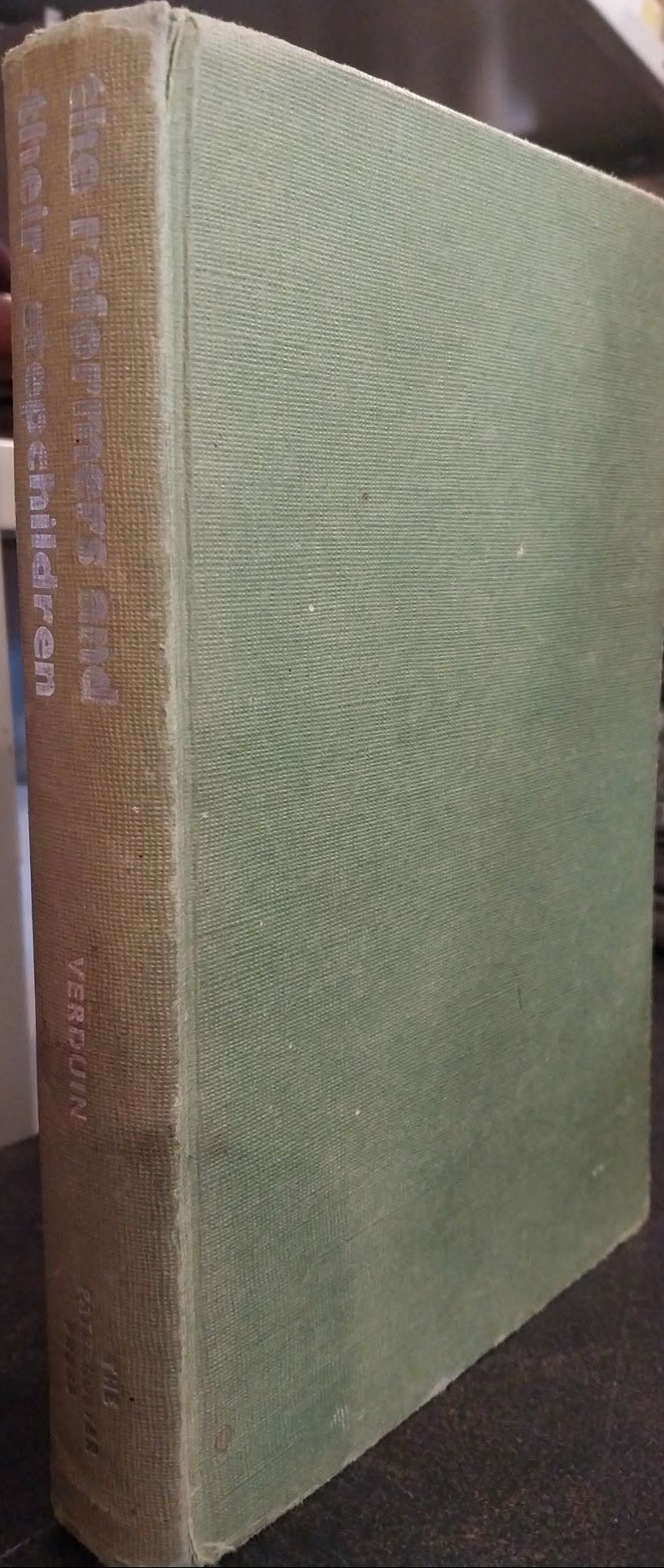 A vintage hardcover book titled 'The Forgotten Mind' by Verhulst, featuring a textured sage green cloth cover and a tan cloth spine, photographed on a shelf.